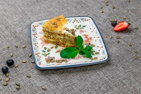 Close-up of appetizing slice of homemade pumpkin cake with sour cream and Stock Photos