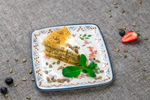 Close-up of appetizing slice of homemade pumpkin cake with sour cream and Stock Photos