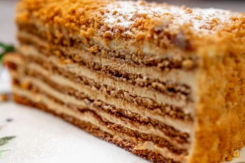 Close-up of appetizing slice of traditional Russian "Medovik" honey cake with Stock Photos
