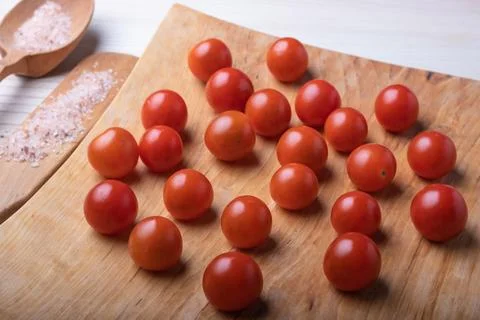 Close-up of appetizing small red cherry tomatoes on a natural wooden surface, Stock Photos