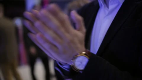 Close-up of applauding man's hands. A man at a concert applauding the actors on Stock Footage 129704255