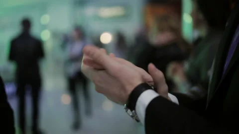 Close-up of applauding man's hands. A man at a concert applauding the actors on Stock Footage 129704704