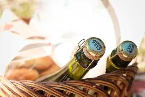 Close up apple cider bottles lying in picnic basket concept photo Stock Photos