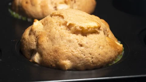 Close up of apple muffins in a tray baking in oven Stock Footage 145536490
