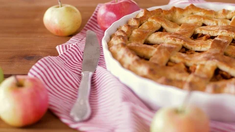 Close up of apple pie and knife on wooden table Stock Footage 95182765