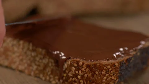 Close Up of Applying Chocolate Spread on Multi Grain Slice of Bread Video stock 130215803