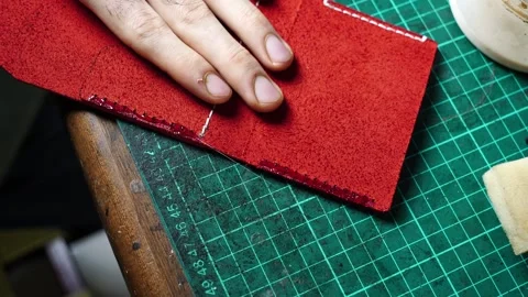 Close-Up Applying Edge Glue on Red Leather Wallet by Hand Stock Footage 314962340