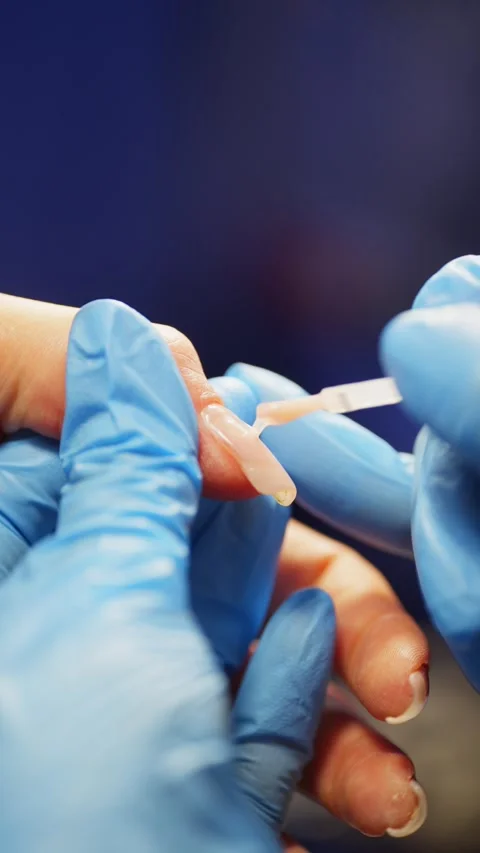Close-up of applying gel base to the nail plate in a beauty salon. Stock Footage 320263485