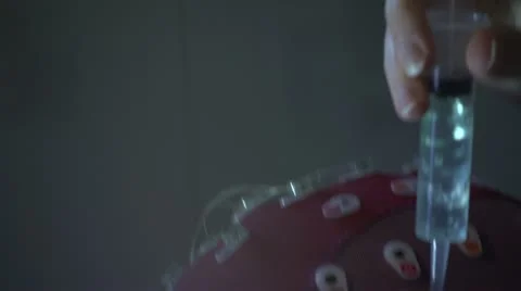 Close up applying gel to brain sensors Stock Footage 20448632