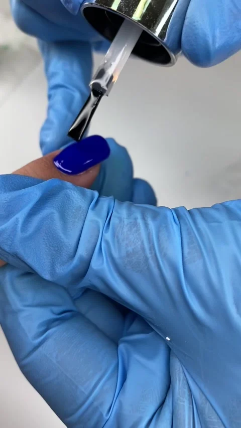 Close up Applying Nails gel polish, blue gel polish, varnish, manicure process Stock Footage 264761810