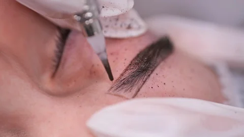 Close-up. Applying paint on the eyebrow, permanent makeup. 4K Slow Mo Stock-Footage 106893320