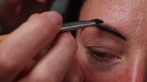 Close-up of applying paint to eyebrows, cosmetic services, master's hands Stock Footage 242512538
