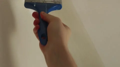 Close up of applying primer brush coat to wall and ceiling joint Stock Footage 340404019