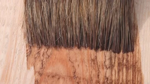 Close-up of applying a protective coating and paint to a wooden board. Stock Footage 157749539