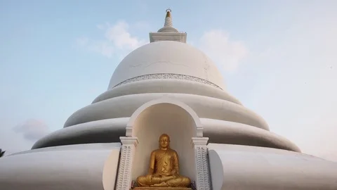 Close approach to buddhist stupa with golden Buddha statue. Dolly shot Video stock 76167053