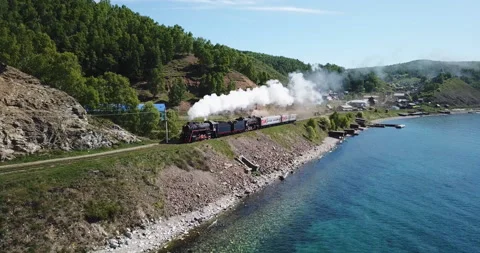 Close approach passengers train Trans Siberian railway brick bridge. Lake Baikal Stock Footage 123406577