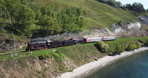 Close approach passengers train Trans Siberian railway brick bridge. Lake Baikal Stock Footage 123412183