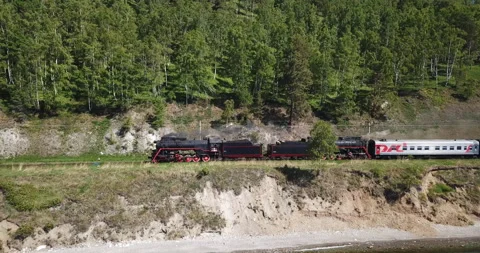 Close approach passengers train Trans Siberian railway brick bridge. Lake Baikal Stock Footage 123420019