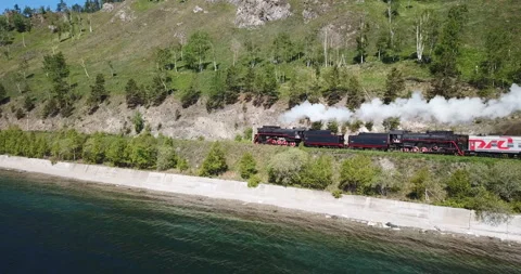 Close approach passengers train Trans Siberian railway brick bridge. Lake Baikal Stock Footage 123450729