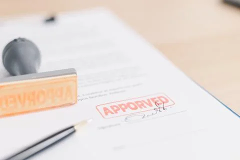 Close up approved stamp on signed document with pen on desk, concept of suc.. Stock Photos