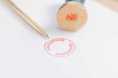 Close up approved stamp on signed document with pen on desk, concept of suc.. Stock Photos