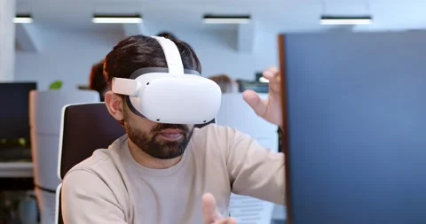 Close up of Arab man in VR glasses moving hands in air. Male in headset having Stock Footage 179989088