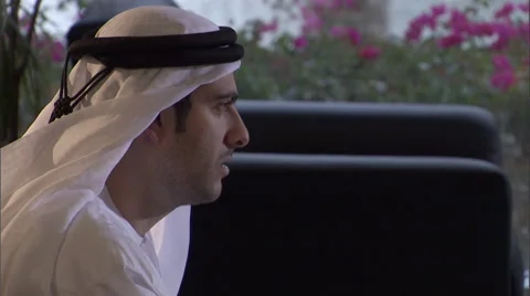 Close-up of an Arabic businessman, while camera moves towards man sipping Stock Footage 46868091