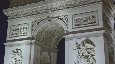 Close up of the Arc de Triomphe sculptures at night in Paris, France. Tilt-up Stock Footage 329478201