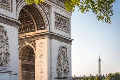 Close-up of the Arch of Triumph with the Eiffel Tower in the distance on a be Stock Photos