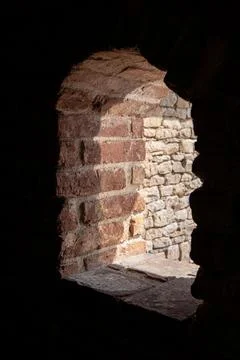Close up of an arched brick window in a castle. Stock Photos