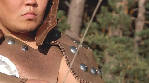 Close-up archer with oriental appearance is aimed with an arrow. Stock Footage 82571212