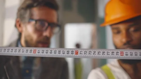 Close up architect and builder using ruler measuring distance in new house Stock-Footage 142207973
