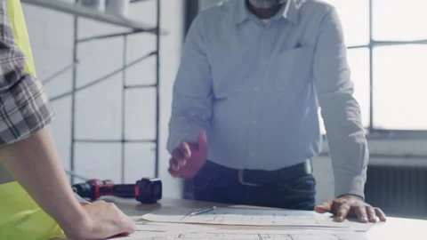 Close Up of Architect and Construction Worker Shaking Hands on Building Site Stock Footage 332249744