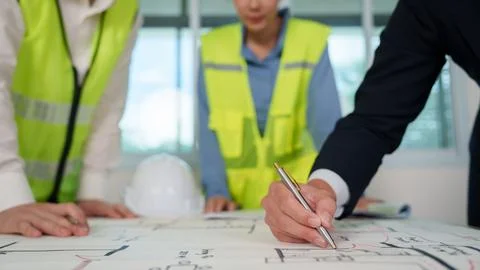 Close up of architect hand drawing on blueprint floor plan for construction Stock Photos