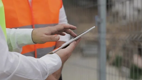 Close up of architect hands using tablet near construction site. The builder and Stock Footage 109488524