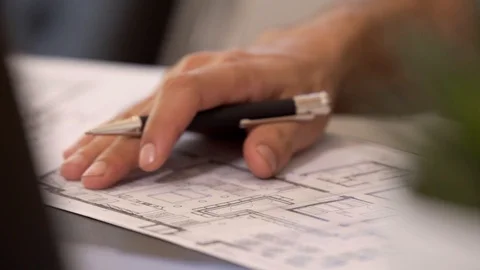 Close up of an architect who scribbles notes on a construction plan Stock Footage 118380463
