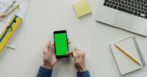 Close up of the architect work desk with a laptop and black vertical smartphone Stock Footage 96187393