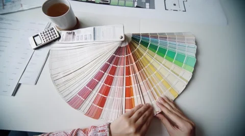 Close Up Of Architects Discussing Plan Together At Desk With Blueprints Stock Footage 56947023