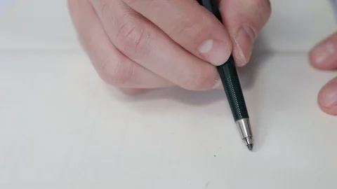Close-up of architect's hand drawing a sketch and writing down measurements Stock Footage 125873104