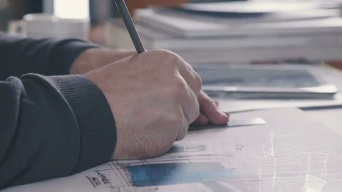 Close-up: the architect's hands on the table. Drawings Stock Footage 73668948