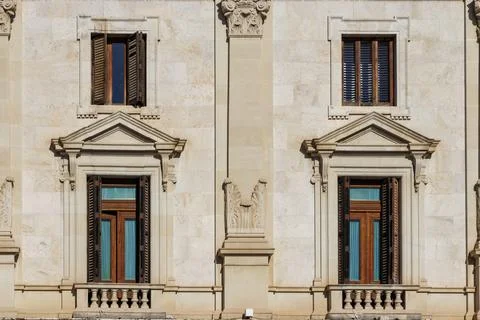 Close-up of an architectural facade featuring ornate stone carvings and wooden 스톡 사진