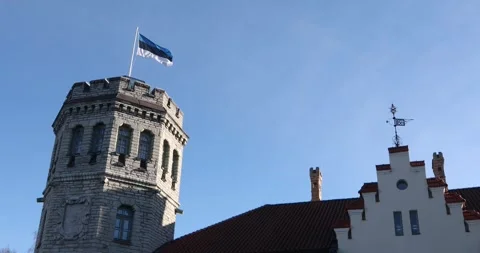 Close-up architectural view of a historic stone tower with the Estonian flag Stock Footage 320168965
