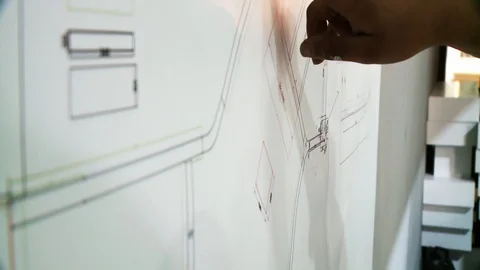 Close up of archtect pointing at building drawing on blueprint. Building project Stock Footage 128929305
