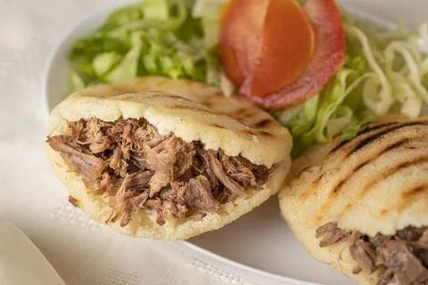 Close up of Arepas, typical Venezuelan food, made with maize and filled wit.. Stock Photos