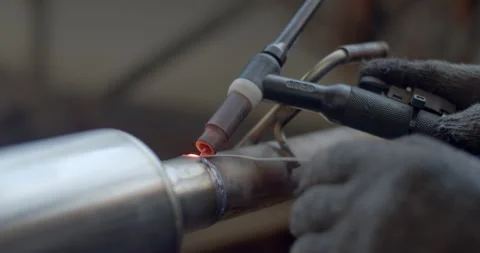 Close up argon welding.Car pipe welding.The hand of a mechanic or welder. Stock Footage 281441399