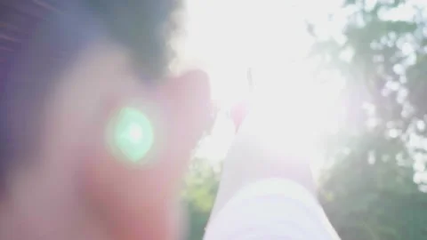 Close up arm of boy point sword forward to  big trees in the park Stock Footage 173352022