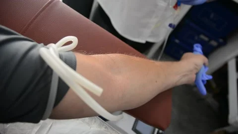Close up arm of a man who donates blood. Male donor gives blood in a mobile bloo Stockbeeldmateriaal 131968257