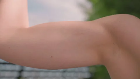 Close up of arm muscle with moles flexing in soft natural light detailed skin Stock Footage 345134727