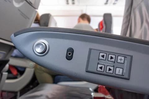 Close Up of Armrest inside an Airplane during Flight Фото