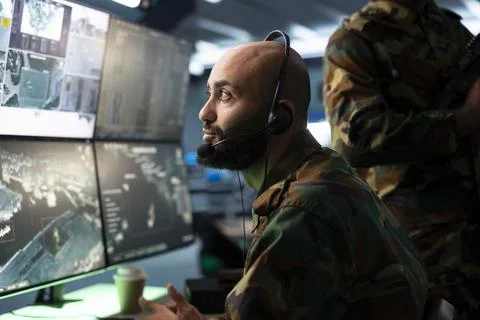 Close up of army operator listening for reports through headset Stock Photos